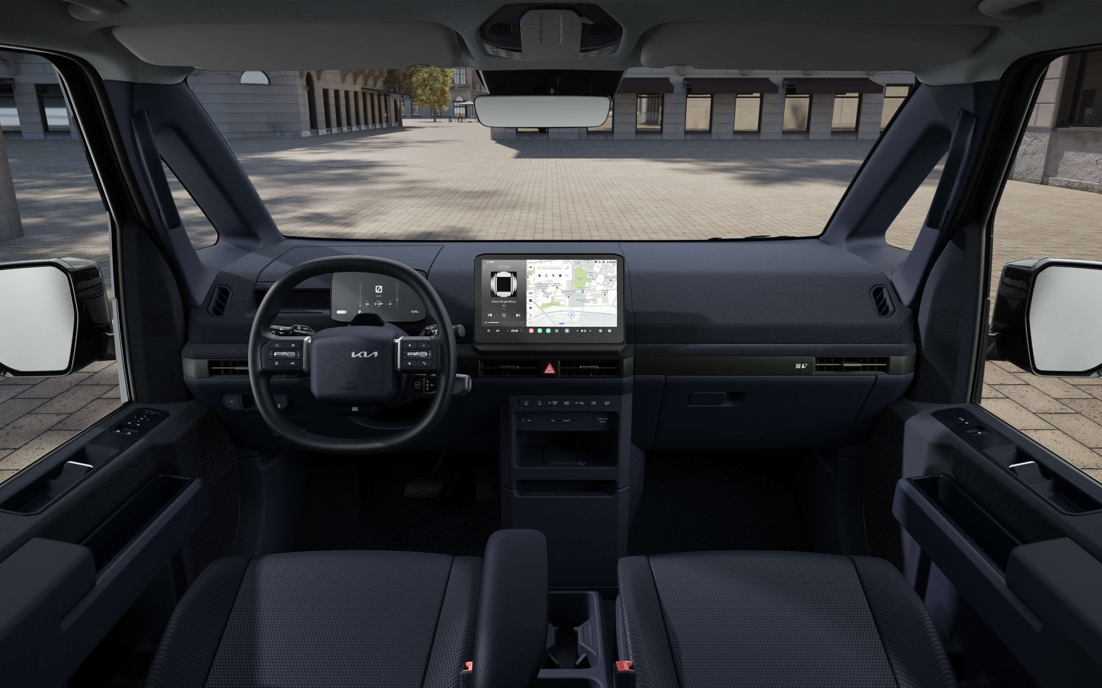 Vordere Innenansicht des Kia PV5 Cargo mit breiter Frontansicht, USB-C-Ladefunktion und robusten Sitzen