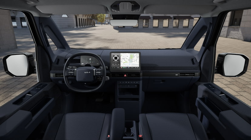 Vordere Innenansicht der Kia PV5 Cargo-Kabine mit digitalem Cockpit und breiter Sicht durch die Windschutzscheibe